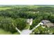 Aerial view of a house and surrounding land with lush greenery at 2075 Country Farms Rd, Port Orange, FL 32128