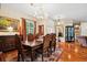 Formal dining room with hardwood floors, chandelier, and large windows at 2075 Country Farms Rd, Port Orange, FL 32128