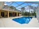 Inviting pool area with covered patio, spa, and outdoor kitchen at 2075 Country Farms Rd, Port Orange, FL 32128