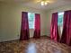 Bedroom with two windows, and burgundy curtains at 401 Cherry St, South Daytona, FL 32119