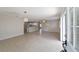 Spacious living room with tile floors and open layout to kitchen at 1106 Carvello Dr, The Villages, FL 32162