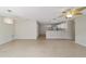 Spacious living area with tile floors and kitchen view at 1106 Carvello Dr, The Villages, FL 32162