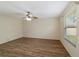 Bright bedroom with wood-look floors and ceiling fan at 1106 Carvello Dr, The Villages, FL 32162