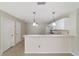 White kitchen with breakfast bar and tile floors at 1106 Carvello Dr, The Villages, FL 32162