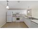 Updated kitchen with white cabinets and appliances at 1106 Carvello Dr, The Villages, FL 32162
