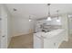 White kitchen with breakfast bar and appliances at 1106 Carvello Dr, The Villages, FL 32162
