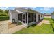 White house exterior with screened porch and landscaped yard at 1106 Carvello Dr, The Villages, FL 32162