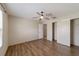 Bright bedroom with wood-look floors and ceiling fan at 1106 Carvello Dr, The Villages, FL 32162