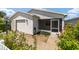 Front view of a single-story home with a screened porch at 1106 Carvello Dr, The Villages, FL 32162