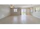 Spacious living room with tile floors and access to backyard at 1106 Carvello Dr, The Villages, FL 32162