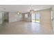 Spacious living room with tile floors and open layout to kitchen at 1106 Carvello Dr, The Villages, FL 32162