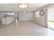 Spacious living room with tile floors and open layout to kitchen at 1106 Carvello Dr, The Villages, FL 32162