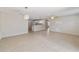 Spacious living room with tile floors and open layout to kitchen at 1106 Carvello Dr, The Villages, FL 32162