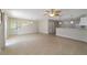 Open living room and kitchen with tile floors and ceiling fan at 1106 Carvello Dr, The Villages, FL 32162
