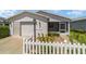 Front view of a single story home with white vinyl siding at 1106 Carvello Dr, The Villages, FL 32162