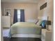 Bright bedroom with a queen bed, dresser, and window coverings at 112 S Chandler Ave, Deland, FL 32724