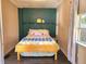 Cozy bedroom featuring a full bed and decorative wall accents at 112 S Chandler Ave, Deland, FL 32724