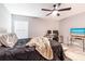 Spacious bedroom with a king-size bed, workspace, and ceiling fan at 3171 Utah Dr, Deltona, FL 32738