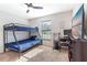 Bedroom with a bunk bed, workspace, and large TV at 3171 Utah Dr, Deltona, FL 32738