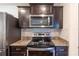 Modern kitchen features stainless steel appliances and granite countertops at 3171 Utah Dr, Deltona, FL 32738