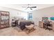 Comfortable bedroom with a king-size bed, workspace, and ceiling fan at 3171 Utah Dr, Deltona, FL 32738