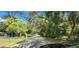 Residential street lined with houses and lush vegetation at 711 Sunset Ave, Orange City, FL 32763