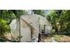 Image shows a damaged greenhouse in the backyard at 711 Sunset Ave, Orange City, FL 32763