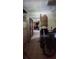 View into kitchen from hallway; older appliances and cabinets at 711 Sunset Ave, Orange City, FL 32763