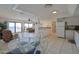 Bright kitchen with ocean views, white cabinets, and glass-top dining table at 4435 S Atlantic Ave # 414, Ponce Inlet, FL 32127