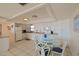 White kitchen with appliances and dining area at 4435 S Atlantic Ave # 414, Ponce Inlet, FL 32127