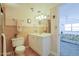 Bathroom with a toilet, vanity, and view into bedroom at 4435 S Atlantic Ave # 414, Ponce Inlet, FL 32127