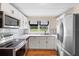 Modern kitchen with white cabinets, stainless steel appliances and hardwood floors at 409 W Beresford Ave, Deland, FL 32720