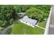 Aerial view of a house and surrounding lot with lush trees at 409 W Beresford Ave, Deland, FL 32720