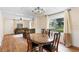Spacious dining area with hardwood floors, chandelier and view into living room at 409 W Beresford Ave, Deland, FL 32720