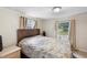 Bright bedroom with double bed, wood flooring and window with curtains at 409 W Beresford Ave, Deland, FL 32720