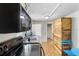 Kitchen boasts modern stove and microwave, wood cabinets and unique pallet wall at 409 W Beresford Ave, Deland, FL 32720