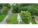 House with a large tree in front and a street alongside at 409 W Beresford Ave, Deland, FL 32720