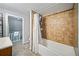 Bathroom with a bathtub and shower, tile surround and updated fixtures at 112 S Chandler Ave, Deland, FL 32724
