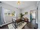 Bright dining room features a table with benches and dark hardwood floors at 112 S Chandler Ave, Deland, FL 32724