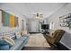 Bright living room with a large TV and comfortable furniture at 112 S Chandler Ave, Deland, FL 32724