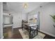 Dining area with a metal table, bench seating, and dark hardwood floors at 112 S Chandler Ave, Deland, FL 32724