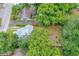 Aerial view showing the house, backyard path, and surrounding trees and neighboring property at 112 S Chandler Ave, Deland, FL 32724