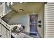 Building entrance with stairs, two chairs, and security door at 600 N Boundary Ave # 101A, Deland, FL 32720