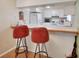Kitchen with breakfast bar and two red stools at 600 N Boundary Ave # 101A, Deland, FL 32720