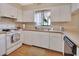 Kitchen with white cabinets, stove, and dishwasher at 600 N Boundary Ave # 101A, Deland, FL 32720