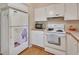 Kitchen with white cabinets, stove and refrigerator at 600 N Boundary Ave # 101A, Deland, FL 32720