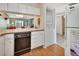 Kitchen features white cabinets, dishwasher, and washer/dryer at 600 N Boundary Ave # 101A, Deland, FL 32720
