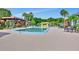 Community pool with lounge chairs and patio tables at 600 N Boundary Ave # 101A, Deland, FL 32720