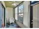 Relaxing sunroom with white chair and large window at 600 N Boundary Ave # 101A, Deland, FL 32720