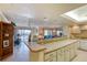 Kitchen with breakfast bar and white cabinets at 1513 Ocean Shore Blvd # 3C, Ormond Beach, FL 32176